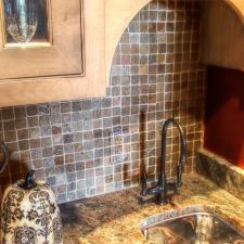 Switch plate designed to blend into this butler pantry mosaic tile backsplash
